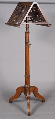 an old wooden music stand with a sheet on top of it