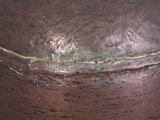 a close up of a brown vase on a table