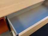 a wooden desk with a drawer in the middle of it