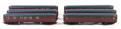 three red and blue train cars sitting next to each other on a white surface