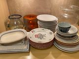 many plates and bowls sitting on a table