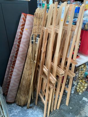 a lot of wooden chairs and brooms on the floor