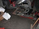 a motorcycle that is sitting on a lift in the garage