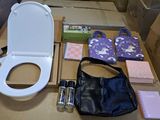 a white toilet and a black bag on a table