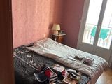 a bedroom with a bed and a door leading to a balcony