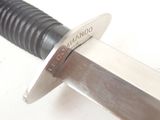 a close up of a knife on a white surface