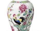 an image of a vase with a bird and flowers on it