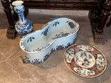 two blue and white vases and a bowl on the floor