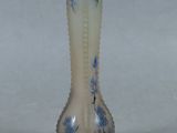 a glass vase that has a blue and white design on it