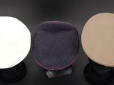 three hats are lined up on top of each other on a black surface