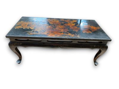 a black table with a floral design on it