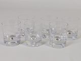 four glasses of water sitting on a table