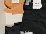 three pairs of black, orange, and white underwear are on a table