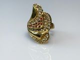 an image of a gold ring with red and white stones