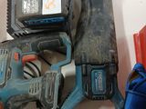 a corded corded drill and a corded hammer on a table