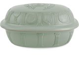 the lid of a green casserole dish is covered with a decorative design