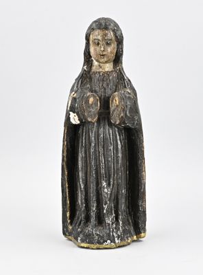 an old statue of a woman with a black robe and a white hat