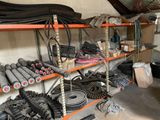 many different types of hoses on the shelves in the garage