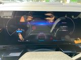 a picture of a car ' s dashboard with a digital display on it