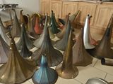 a lot of brass bells that are sitting on the floor