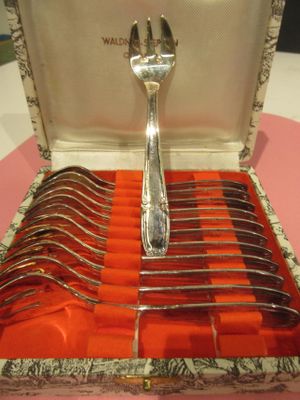 silverware in a box with forks and spoons in it