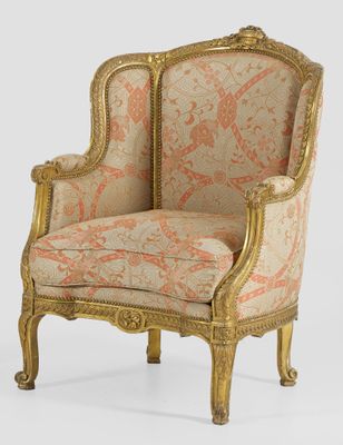 a gold and pink upholstered chair on a white background