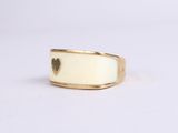a close up of a gold ring with a heart on it