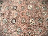 an image of a large oriental rug on a wooden floor