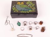 a box with rings, bracelets, and other jewelry on it