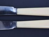 two knives that are sitting on top of a table