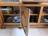 a cabinet with a door open on a kitchen floor