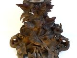 a wooden sculpture of a dragon with flowers on it