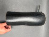 a hand that is holding a black object on a table