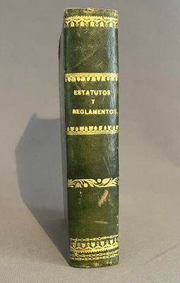 un vieux livre posé sur une table à côté d'une table blanche