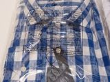 a blue and white checkered shirt in a plastic bag