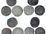 a close up of a bunch of old coins on a white surface