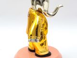 statue of an elephant with a crown on its head and a pipe in its mouth