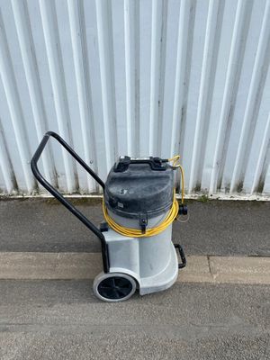 La machine est garée sur le bord de la route, près du mur.