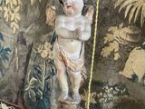 a small statue of a child on a stand