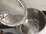 a silver pot with a lid sitting on a counter