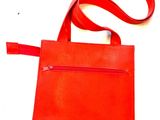 an orange purse with a red strap on a white background