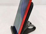 a cell phone that is sitting on a cell phone stand