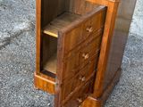 a small wooden cabinet with a drawer on top of it