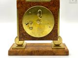 a clock that is sitting on a stand on a table