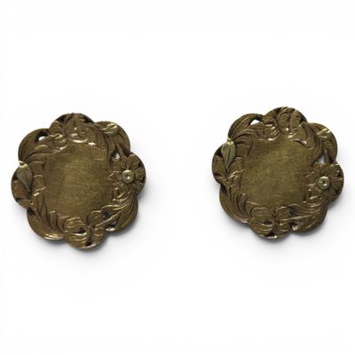 pair of antique brass buttons on a white background