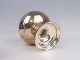 a silver vase that is sitting on a table