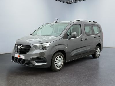 the grey van is parked in a large room with a black floor