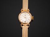 a gold wrist watch with a white dial on a black background