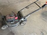 a small lawn mower that is sitting on the ground