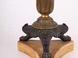 a black and gold table lamp on a wooden base